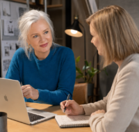 Annabelle Drumm, executive coach for creative leaders, in a coaching session with a senior female client in a creative studio workspace